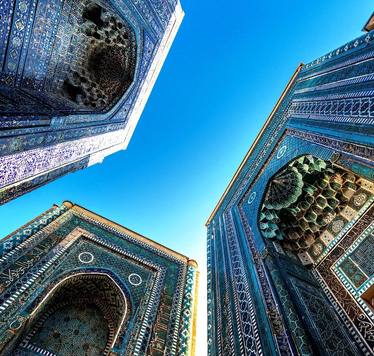 Turquoise-tiled domes and portals against a blue sky in Samarkand